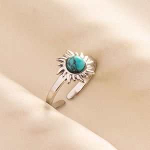 Detailed macro shot of a sunburst silver ring featuring a round turquoise stone inlay