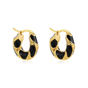 Close-up of 18K gold earrings with black enamel drip oil and micro-inlaid design