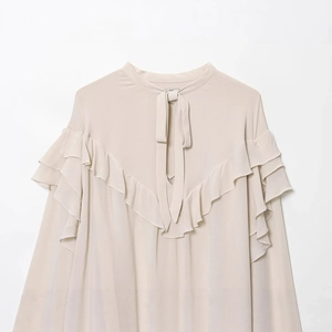 Elegant apricot chiffon blouse with tiered ruffles and bow tie collar in solid color