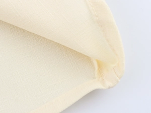 Macro shot of apricot fabric showing detailed stitching and premium woven texture