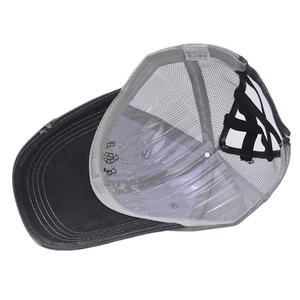 Detail of cross-back elastic straps and care label on ponytail baseball cap