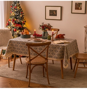 Detailed blue floral tablecloth with beige lace trim on a festive Christmas dinner table
