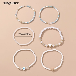 Set of 6 beaded bracelets with evil eye and heart pendants in bohemian white and blue style