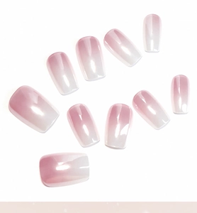 Detailed view of pink and white ombre square press-on nails with a high-gloss finish