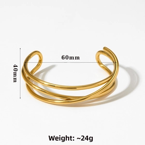 Detail view of gold layered crossover open bangle with 40mm width and 60mm inner diameter