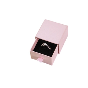 Pink drawer jewelry box with black velvet lining and open design showing ring interior
