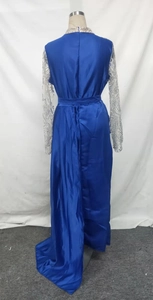 Detail of royal blue evening gown with silver sequin sleeves and a long floor-length train