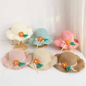 Multi-colored children's straw sun hats with decorative flowers and lace ribbons for summer.
