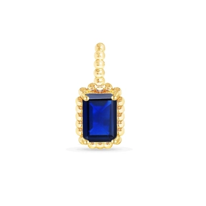 Detailed close-up of emerald-cut deep blue sapphire pendant with gold milgrain border