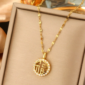 Golden Fu character pearl pendant necklace with circular zircon stones in a jewelry box