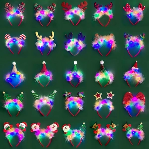Macro detail of LED Christmas headbands with reindeer antlers and festive feathers