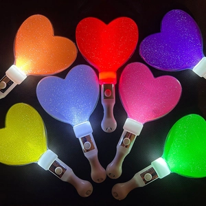 Macro shot of heart-shaped LED glow sticks in seven colors with glitter texture