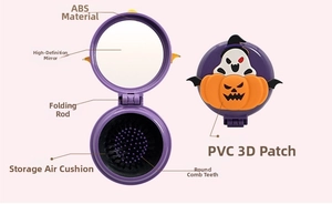 Detail showing foldable Halloween pumpkin hairbrush with mirror and massage bristles