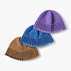 Three thick knit beanies in purple, blue, and brown with contrast stitching details