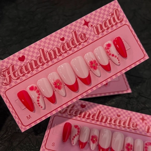 Handmade red and pink floral press-on nails with French tips and rhinestone accents