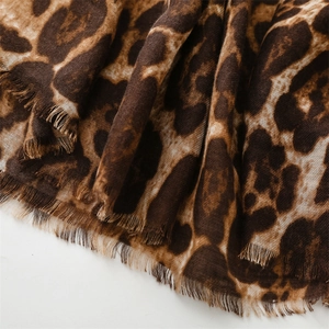 Detail view of cotton-linen feel leopard print scarf with soft fringe edges