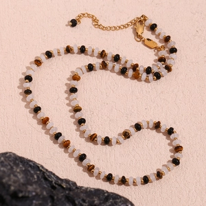 Detail of beaded necklace with tiger eye and gold beads, featuring extension chain and clasp