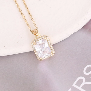 Gold emerald-cut cubic zirconia pendant necklace with micro-pave halo setting