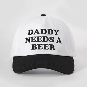Close-up of contrast baseball cap with Daddy Needs A Beer embroidery and cotton texture