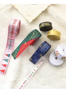 Detail of colorful Christmas ribbons with festive patterns on white faux fur background