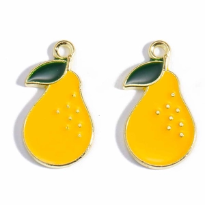 Detail of two yellow pear charms with green leaves and gold plated edges for DIY jewelry