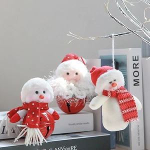 Detailed close-up of plush snowman and metal bell Christmas tree ornaments in red and white