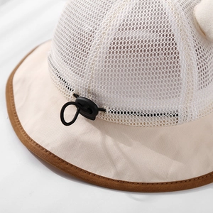Close-up of breathable mesh fabric and adjustable drawstring on baby sun hat