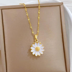 Detailed close-up of a rotating sunflower pendant with pavé crystals in a jewelry box