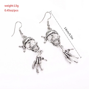 Detail of silver pirate skull earrings showing 14cm length and weight specifications