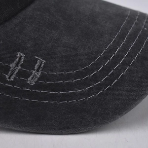 Macro shot of washed cotton baseball cap brim with distressed edges and white stitching
