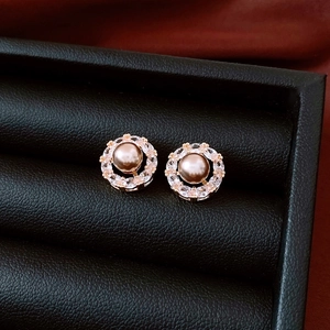 Macro view of 14k gold plated pearl flower earrings with white zirconia details