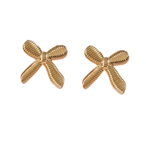 Golden bow stud earrings with textured surface and asymmetrical hollow design