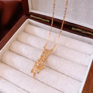 18K gold-plated necklace with rectangular rhinestone pendant and tassels in jewelry box