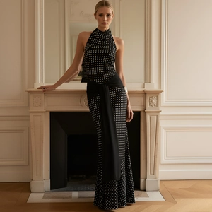 Elegant black polka dot halter neck backless dress with a stylish waist tie