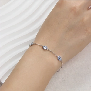 Detailed view of 925 silver Evil Eye bracelet with blue zircon on a woman's wrist