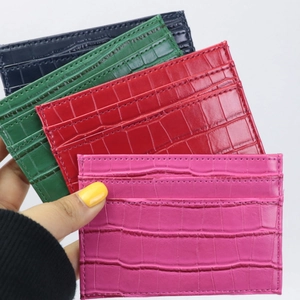 Close-up of colorful ultra-slim PU leather card holders with crocodile texture and stitching