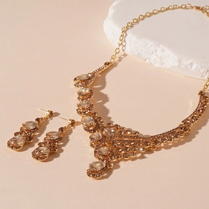Luxurious gold jewelry set featuring champagne teardrop rhinestone necklace and earrings