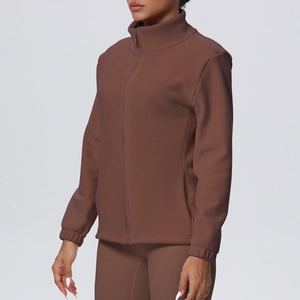 Detail view of brown fleece sports jacket showing stand-up collar and premium texture