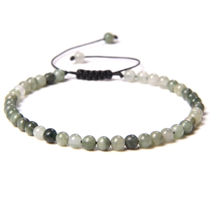 Macro detail of 4mm natural stone beaded bracelet with adjustable black braided cord
