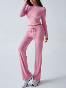 Detailed view of pink Y2K slim-fit long-sleeve crop top and matching lace-up flare trousers