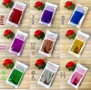 Nine colors of foil fringe curtains in retail packaging with hanging cards for parties