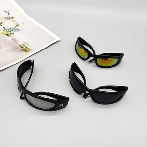 Detail view of sports sunglasses featuring silver crescent moon logo on wide black frame temples