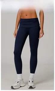 Close-up of high-waist yoga pants in emblem blue with textured crossover waistband