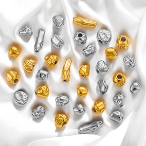 Baroque style stainless steel beads in gold and silver finish on white silk