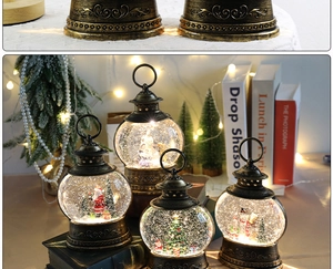 Detail of vintage bronze Christmas snow globe lanterns with Santa and LED light scenes