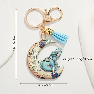 Detail of bohemian crescent moon elephant keychain with blue tassel and size specs