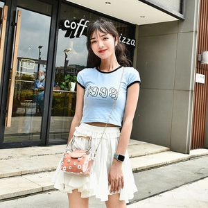Transparent daisy print 2-in-1 shoulder bag styled with blue t-shirt and white pleated skirt