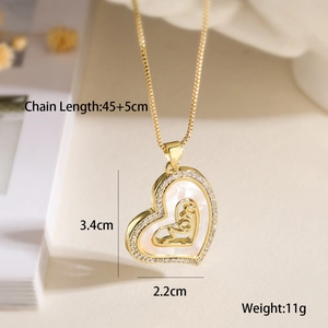 Detail of gold heart pendant with shell inlay and cubic zirconia on beige background