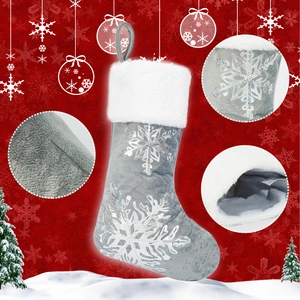 Detailed view of grey plush Christmas stocking with silver sequin snowflakes and white faux fur