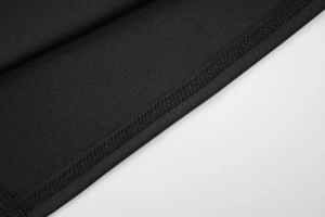 Close-up of high-density stitching and premium black knit fabric on a slim-fit T-shirt
